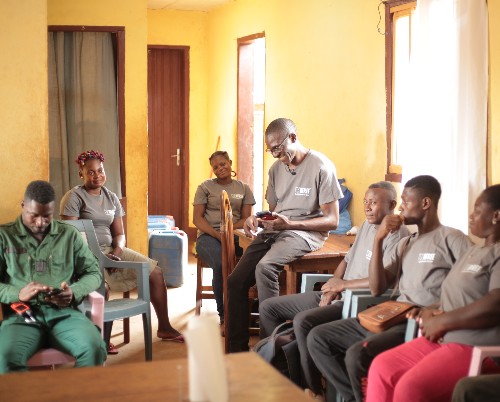 A group of people wearing Born Free T-shirts, sitting in a room together as if having a meeting