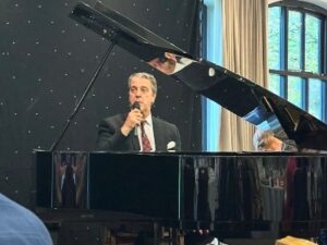 A man sitting at a grand piano