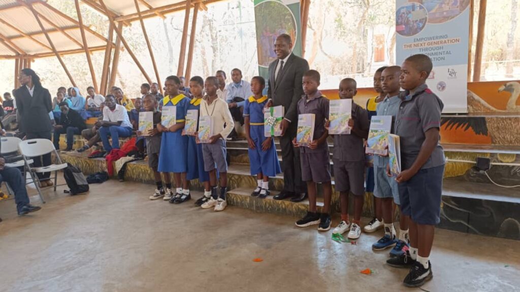 A group of school children in Malawi, holding up certificates